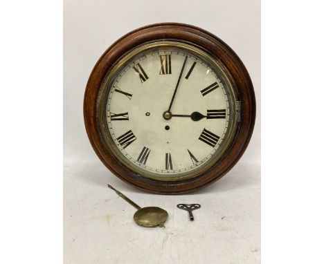 A VINTAGE OAK CASED RAILWAY CLOCK WITH PENDULUM AND KEY 