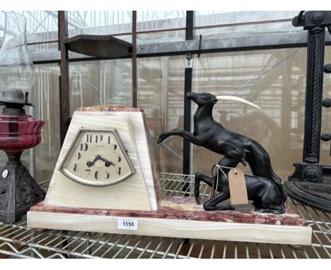 AN ART DECO ONYX, MARBLE AND BRONZE ANTELOPE CLOCK BEARING THE NAME TOURCOIND AND COMPLETE WITH KEY 