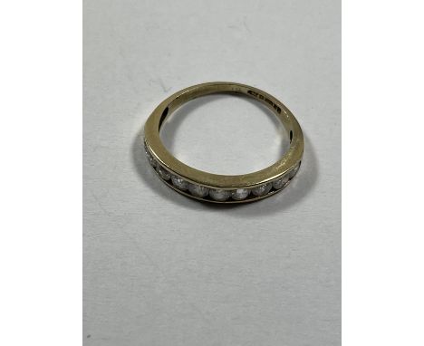 A 9 CARAT GOLD RING WITH TEN IN LINE CUBIC ZIRCONIAS SIZE K 