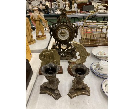 A QUANTITY OF VINTAGE BRASSWARE TO INCLUDE A LARGE MANTLE CLOCK WITH FIGURES, A FISH ON A PLINTH, A PAIR OF CANDLESTICKS AND 