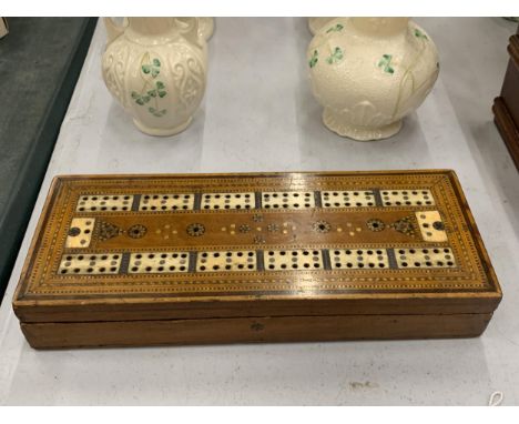 AN MAHOGANY CRIBBAGE BOARD INLAID WITH BONE CROSS BANDING 