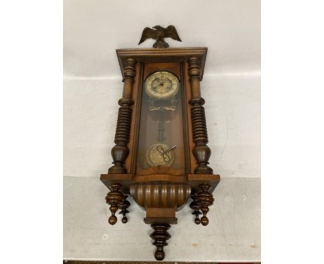 A MAHOGANY CASED VIENNA WALL CLOCK WITH EAGLE DESIGN TOP, WITH PENDULUM AND KEY 