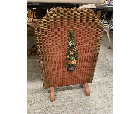 A VINTAGE WOODEN AND BASKET WEAVE FIRE SCREEN, RED WITH FLORAL DECORATION 