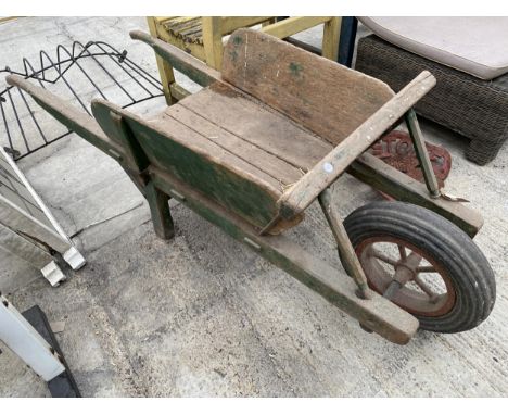 A VINTAGE WOODEN WHEEL BARROW GARDEN FEATURE/PLANTER 