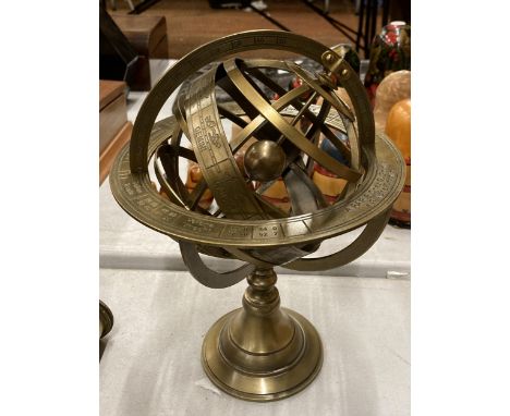 A BRASS REVOLVING GLOBE STYLE DESK COMPASS WITH BIRTH SIGNS 