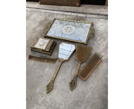 A DECORATIVE BRASS DRESSING TABLE SET TO INCLUDE A TRAY, BRUSH, MIRROR AND TRINKET BOX ETC 