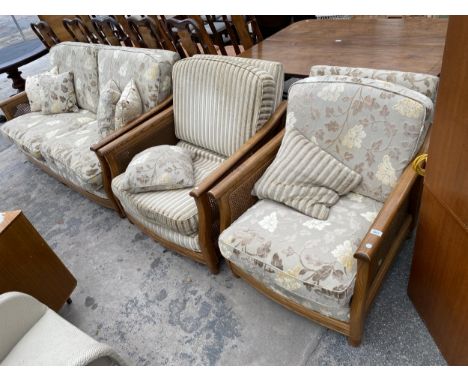 AN ERCOL BERGERE FOUR PIECE SUITE COMPRISING SETTEE, TWO EASY CHAIRS AND A STOOL 