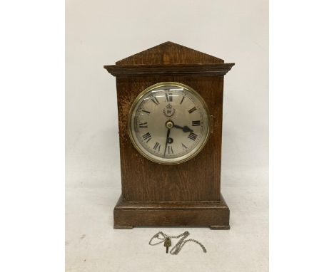 A VINTAGE OAK CASED MANTLE CLOCK WITH 'RAF' MONOGRAM TO DIAL, WITH PENDULUM 