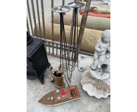 A BRASS COMPANION SET AND A DECORATIVE METAL CANDLE STICK 