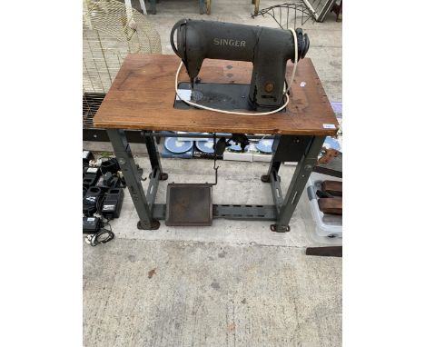 AN INDUSTRIAL SINGER SEWING MACHINE WITH BENCH AND TREADLE BASE 