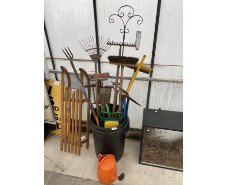 A DUSTBIN CONTAINING AN ASSORTMENT OF GARDEN TOOLS TO INCLUDE FORK, SPADE, RAKES AND BRUSHES ETC 
