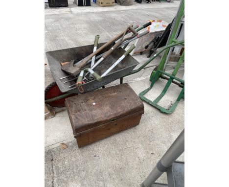 A WHEEL BARROW, A METAL TOOL CHEST AND AN ASSORTMENT OF TOOLS TO INCLUDE HAMMERS, AN AXE AND A FORK ETC 