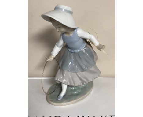 A Nao figure of a child with a hoop. 