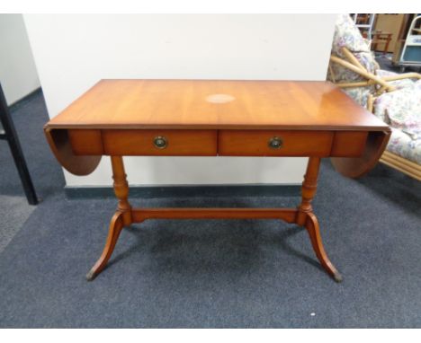 A yewwood flap sided sofa table fitted with two drawers 