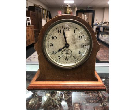 An Edwardian mahogany and pine mantel clock with silvered dial and key 