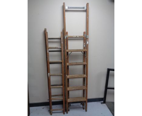 A folding wooden step ladder together with twin section extension ladder 