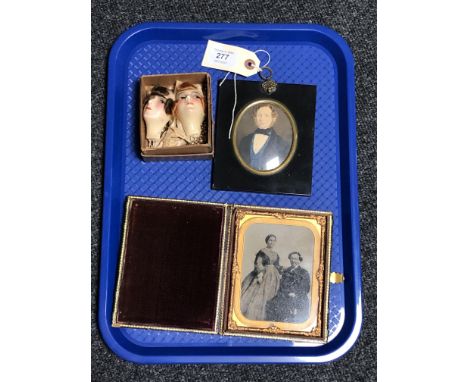 A 19th century portrait miniature depicting a gentleman wearing a jacket, a further Victorian tooled leather folding photogra