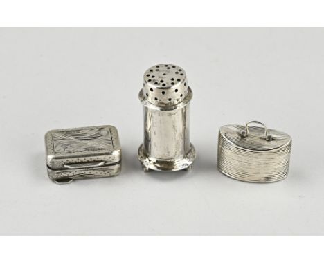 Two silver boxes and a shaker. A rectangular box with engraving, 835/000, 3.5x2.5x1.4cm. and a boat-shaped box with ribbed wo