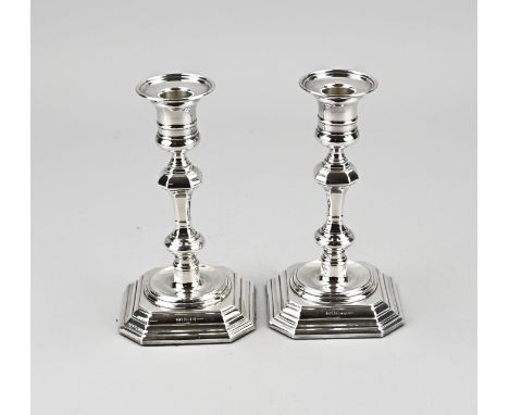 Two silver candlesticks, 925/000, on a contoured square base with a pillar provided with a round light. MT.: R.Carrs Ltd. She