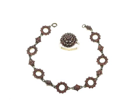 Gold on silver ring and bracelet with garnet. Ring with a double rosette set with garnet stones, ø head 16 mm. And a bracelet