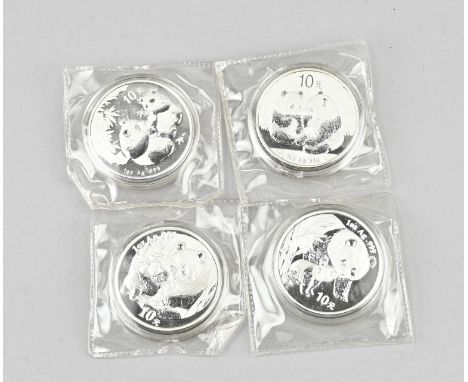 Four Chinese silver coins with pandas. 2004, 2005, 2009. Size: Ø 4 cm. In good condition.