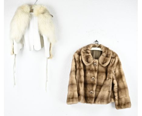 Two short ladies fur coats. Size: L 50 - 66 cm. In very good condition.