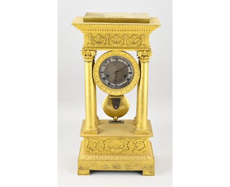 French fire-gilt bronze Empire mantel clock with Corinthian columns. Eight-day movement, half-hourly striking, spring pendulu