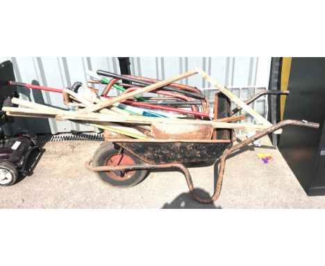 Wheel barrow of vintage tools to include spades, shovels etc 