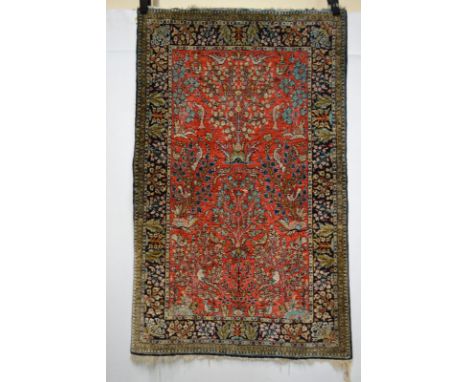 Qum silk rug, south central Persia, mid-20th century, 4ft. 2in. x 2ft. 7in. 1.27m. x 0.79m. Small damage to centre with patch