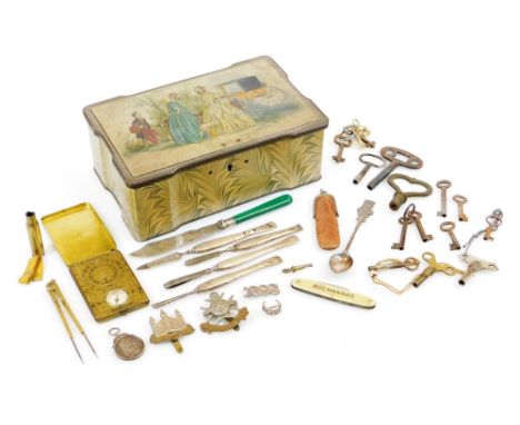 A tin containing various bygones collectables, etc., cap badges, Notts and Derby two coloured, 5cm high, various others, Buch