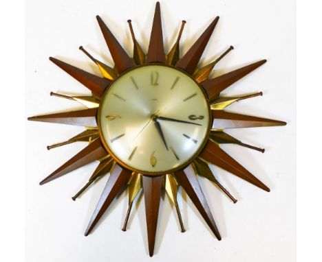 A vintage Metamec Sunburst wall clock, the 17cm diameter dial with baton and Arabic numerals with a teak and metal star burst
