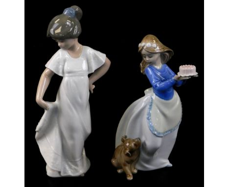 Two Nao figures, comprising a girl in flowing robes, 23cm high, and another holding cake aside puppy, printed marks beneath. 