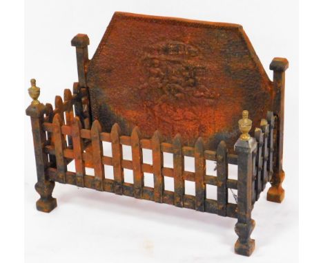 A dog grate, with cast iron shaped panelled back, with lattice work design fronted by columns with brass urn finales and a ra