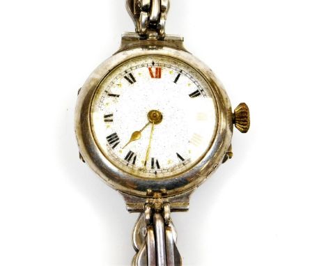 An early 20thC wristwatch, with fancy 2cm diameter enamel dial with Roman numerals, in a white metal case marked 925, with el