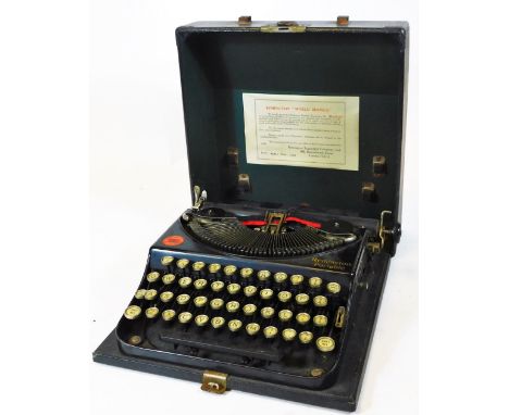 A Vintage Remington portable typewriter, in black colour way with articulated keys in pressed case 30cm wide, marked made in 
