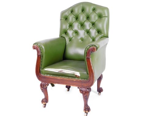 A 19thC mahogany library armchair, with button back arms and seat upholstered in later green leatherette, on scroll topped ha