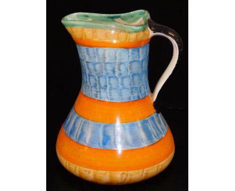 A mid 20thC Myott &amp; Sons pottery jug, of shaped form, decorated with a stripe pattern predominately in orange, blue, yell