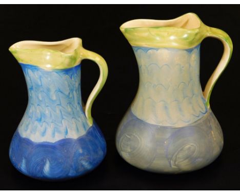 A graduated pair of mid 20thC Myott &amp; Sons pottery jugs, no. 8509, each in blue and green striped pattern, 22cm high, etc