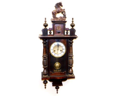 A 20thC Black Forest wall clock, of small proportion, with horse finial raised above a 14cm diameter dial flanked by quarter 