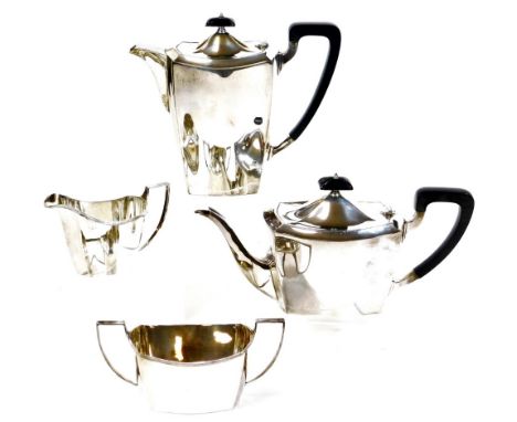 A George V silver four piece tea service, of plain form, comprising teapot, water jug 20cm high, milk jug and two handled sug