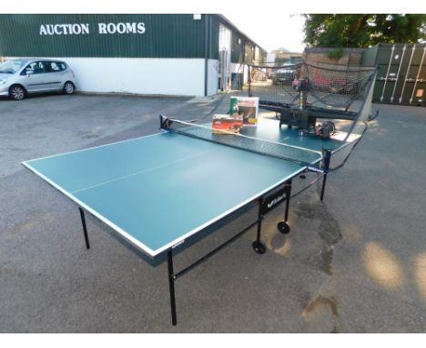 A Butterfly table tennis table, together with a net, balls, Newgy Pong-Master electronic table tennis game and a Robo Pong ta