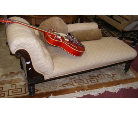 A Victorian chaise longue with button backrest and padded armrest