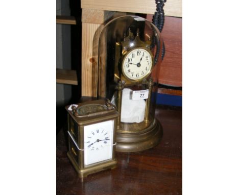 A torsion clock under glass dome, together with a carriage clock