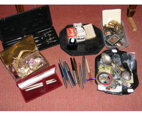 A shelf of collectable items, including pens, costume jewellery, technical drawing instruments