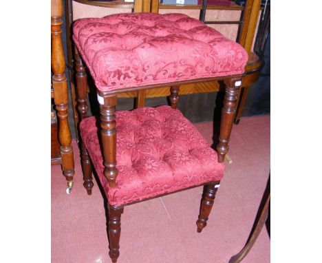 A pair of antique stools with red button back padded seats standing on turned supports