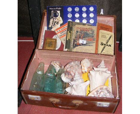 An old suitcase containing collectable cod bottles, shells, etc.