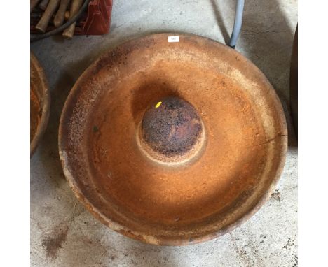 A circular cast iron pig trough