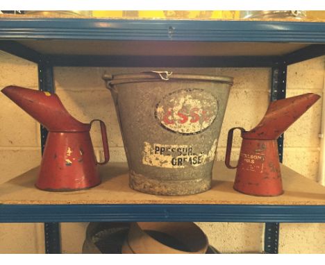 An Esso grease pail and two oil jugs