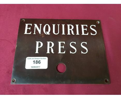 An enamel sign "Enquiries Press"