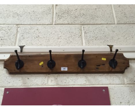 An early 20th Century pine and iron coat rack and hooks